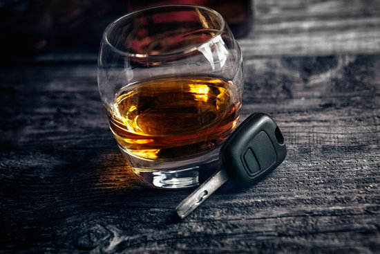 Glass with whiskey and car keys
